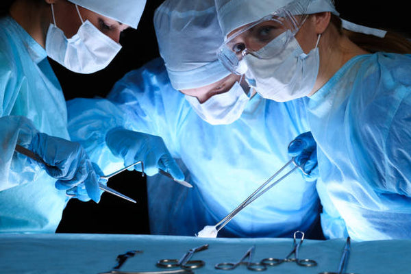 group-of-surgeons-wearing-safety-masks-performing-operation-medicine-concept